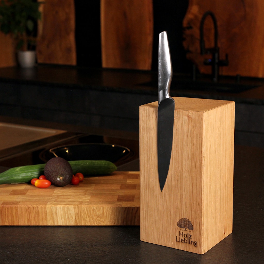 A monolith-style magnetic knife block made from solid oak